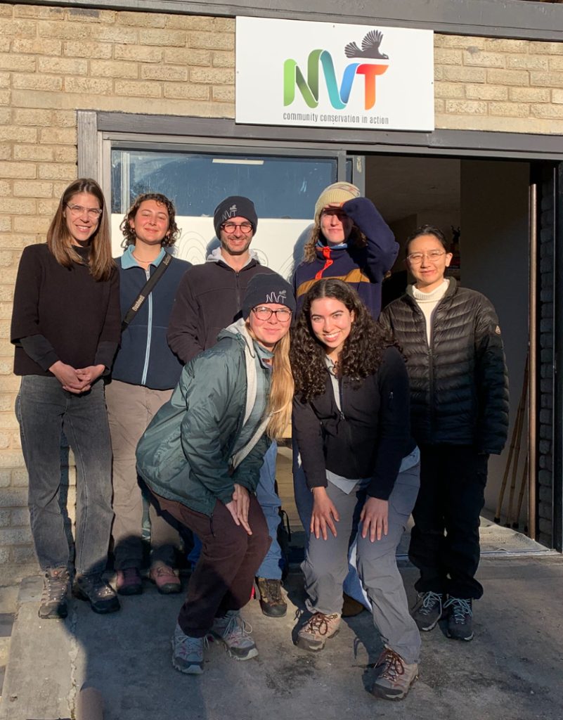 Seven people standing in front of NGO office door