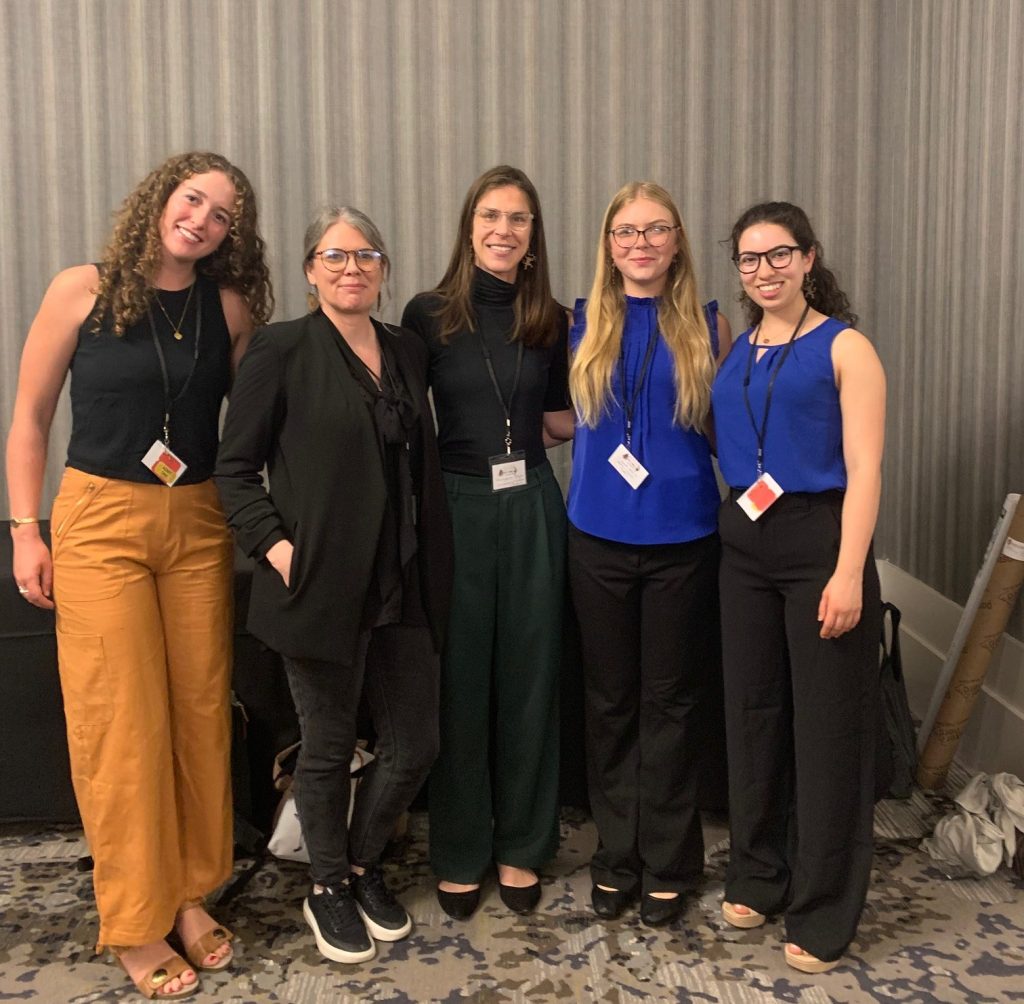 Five white women in conference clothes
